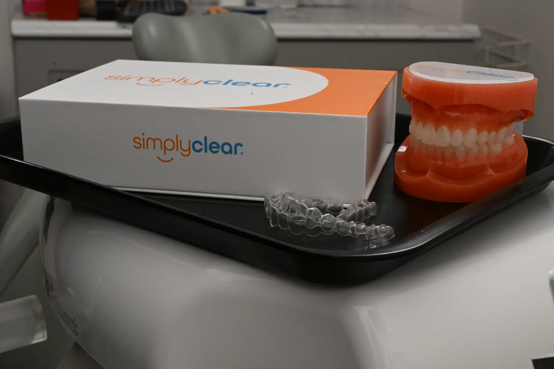 A SimplyClear® box, dental model, and aligner on a treatment tray